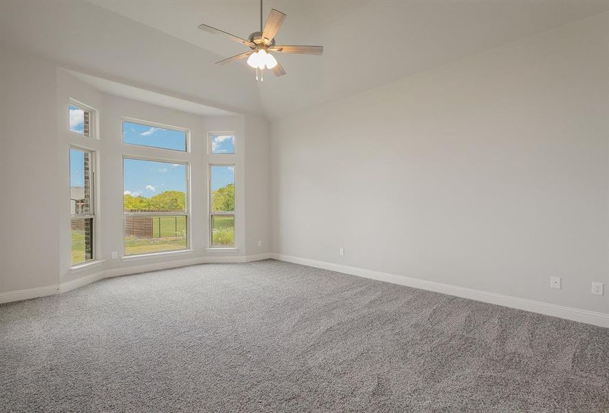 Spare room with carpet and ceiling fan