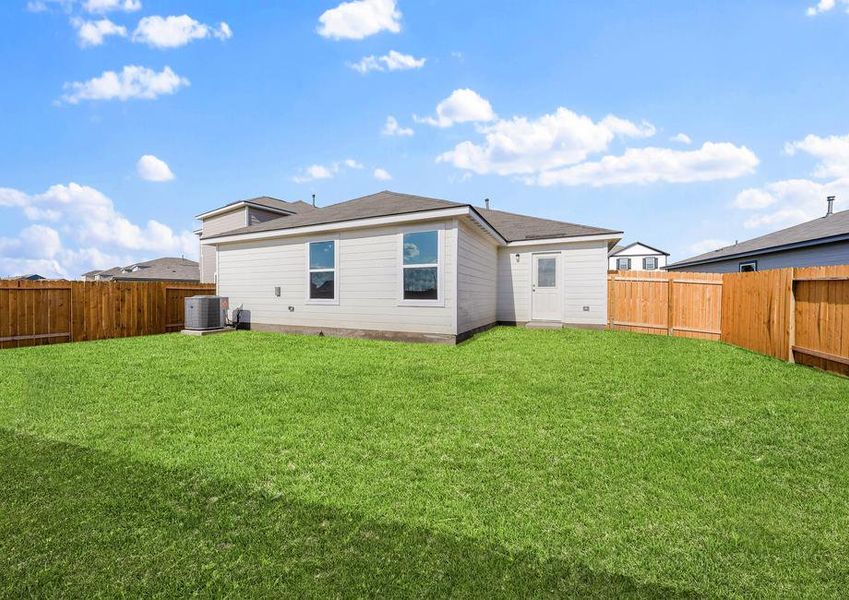 The backyard with grass landscaping.