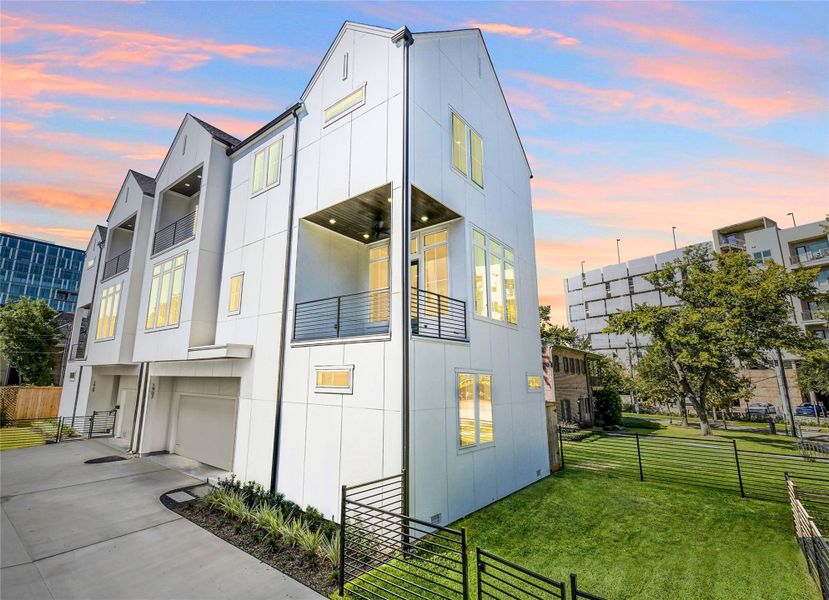 Sleek modern elevation featuring durable cement board siding, energy-efficient windows, and private fenced yard. Multiple balconies and refined architectural lines define this luxury residence minutes from the Texas Medical Center.