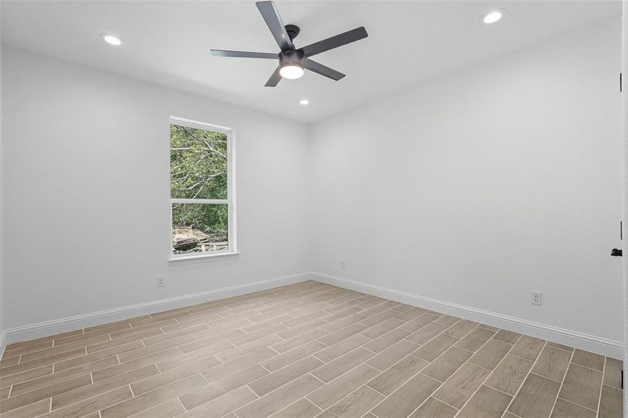Unfurnished room featuring wood tiled floors, recessed lighting, and ceiling fan Unfurnished room featuring wood tiled floors, recessed lighting, and ceiling fan
