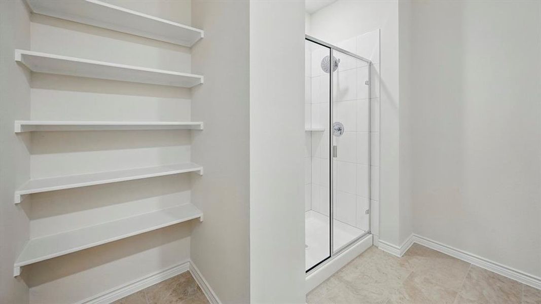 Walk-in shower with clear glass enclosure and chrome fixtures Walk-in shower with clear glass enclosure and chrome fixtures