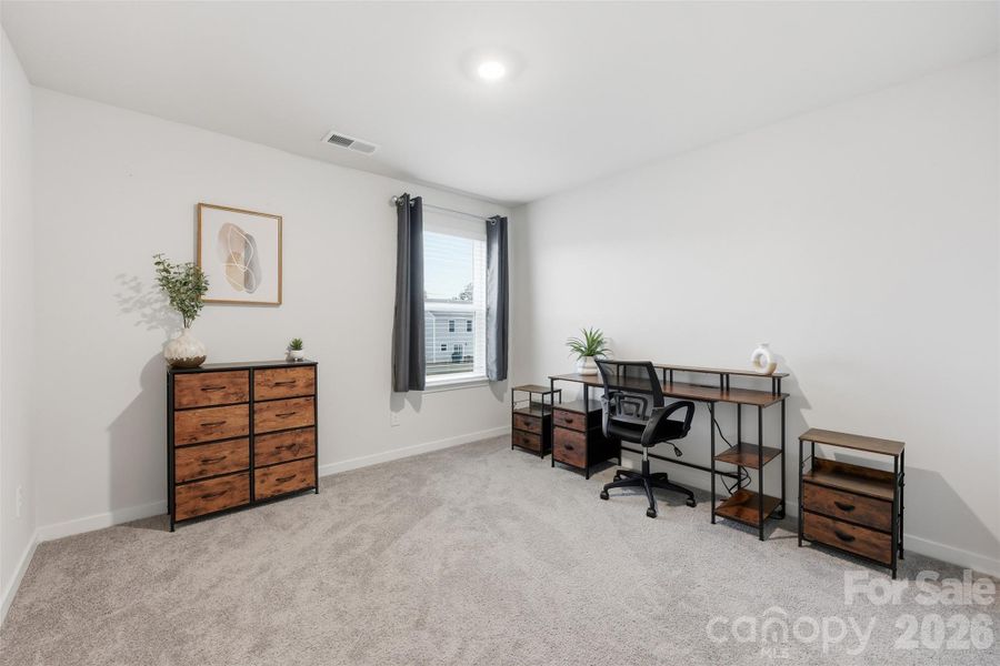 secondary bedroom with walk-in closet