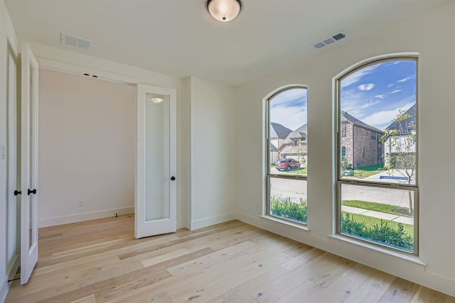 Spare room featuring light wood-type flooring and baseboards Spare room featuring light wood-type flooring and baseboards