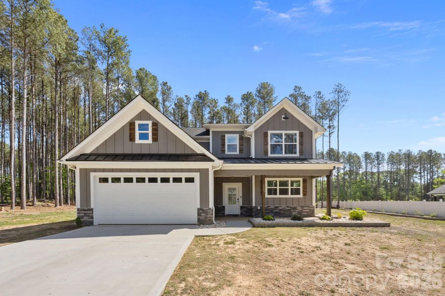 Front exterior of a new home in , Monroe, NC, highlighting curb appeal (Image 26).