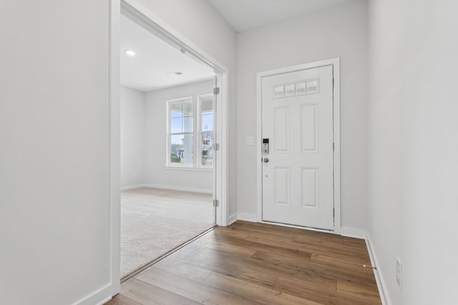 A hallway with white doors. A hallway with white doors.
