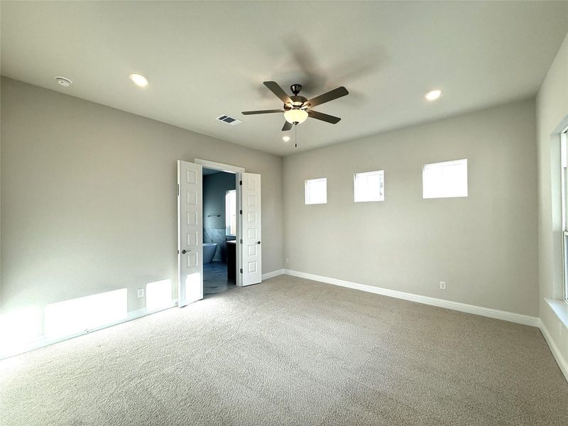 Unfurnished bedroom featuring recessed lighting, light carpet, ceiling fan, and connected bathroom