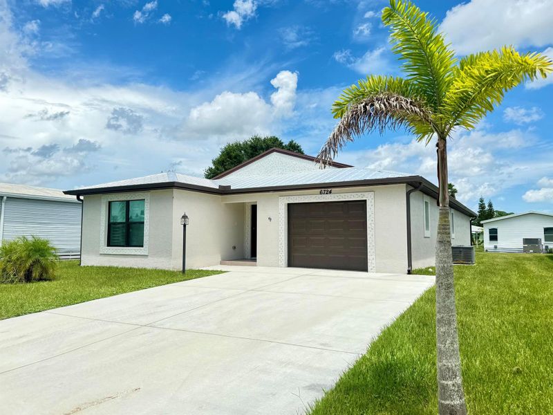 Front exterior of a new home in , Fort Pierce, FL, highlighting curb appeal (Image 2).