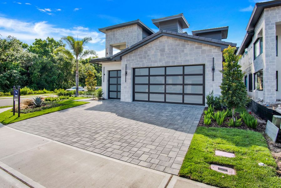 Front exterior of a new home in Hampton Green at Providence, Davenport, FL, highlighting curb appeal (Image 12).