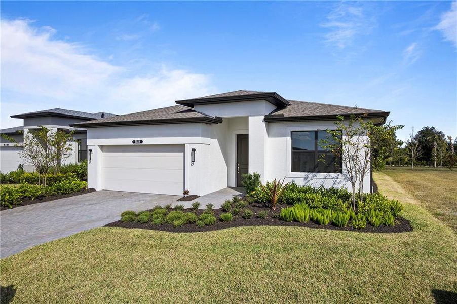 Front exterior of a new home in Woodland Preserve, Parrish, FL, highlighting curb appeal (Image 2).