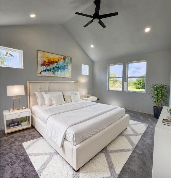 Carpeted bedroom featuring ceiling fan and lofted ceiling. Virtual view