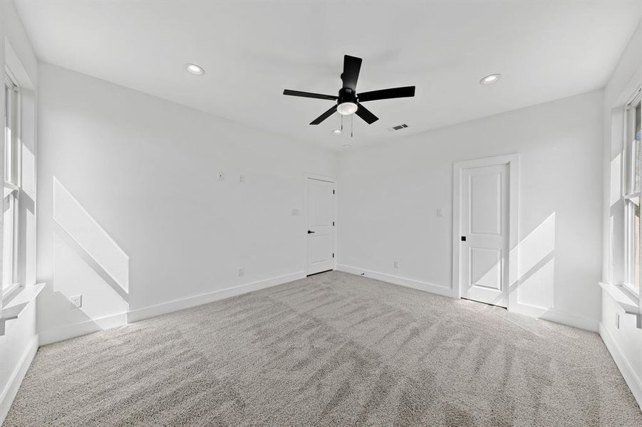 Unfurnished room with light colored carpet, recessed lighting, visible vents, and baseboards