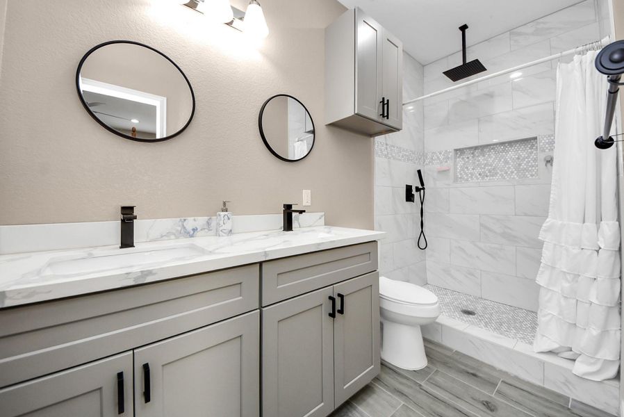 Primary Bath with double sink vanity and waterfall rain shower