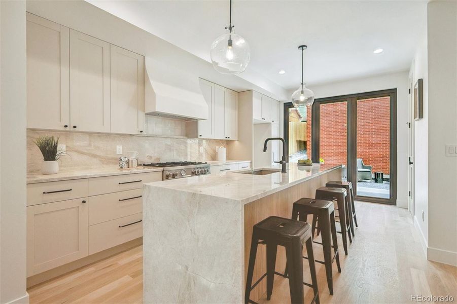 Gourmet kitchen with custom cabinets , large pantry  and Nano door to back patio