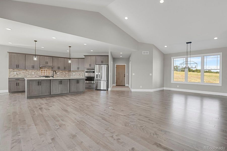 Kitchen, Dining, and Garage entrance view from fireplace