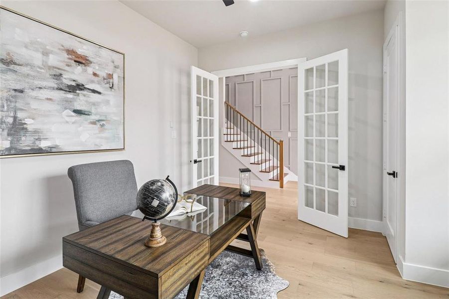 Light wood-finish flooring complements white walls and trim throughout this space