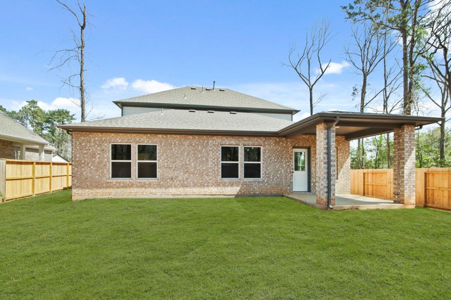 Front exterior of a new home in The Woodlands Hills, Willis, TX, highlighting curb appeal (Image 2). Front exterior of a new home in The Woodlands Hills, Willis, TX, highlighting curb appeal (Image 2).