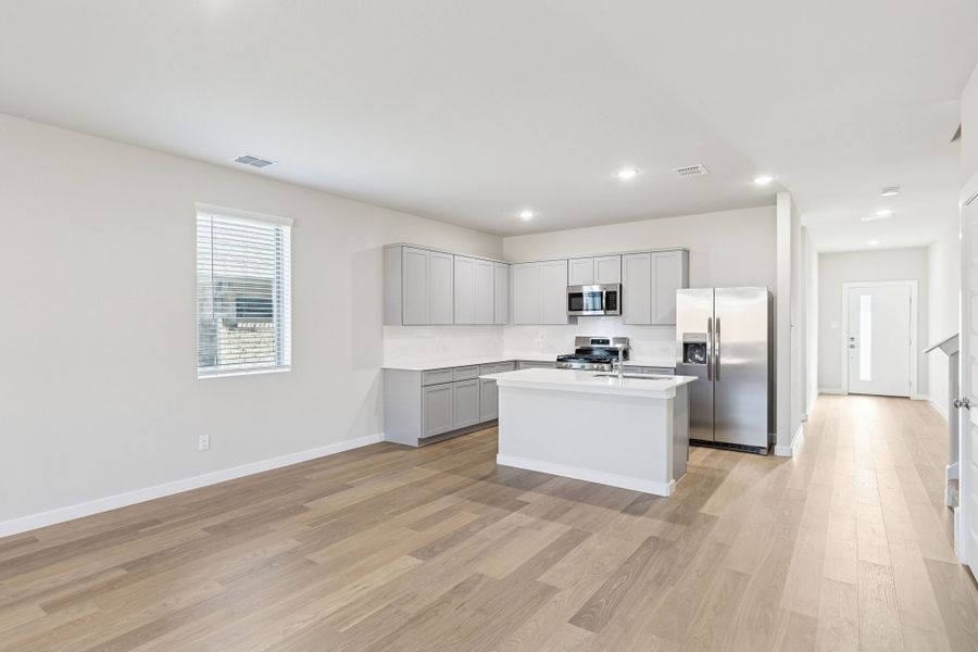 Kitchen and Dining Room in the Haylee home plan by Trophy Signature Homes - REPRESENTATIVE PHOTO