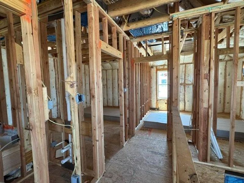Witness new construction in progress, featuring exposed wooden studs and future living spaces.