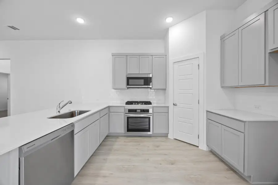 Kitchen in the Pecan II home plan by Trophy Signature Homes – REPRESENTATIVE PHOTO