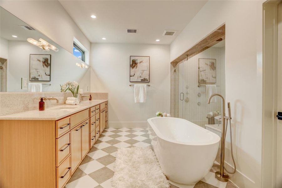 The stunning primary bathroom is sure to impress. With double vanities, a garden tub, and a massive walk-in shower, you'll be able to unwind after a long day.