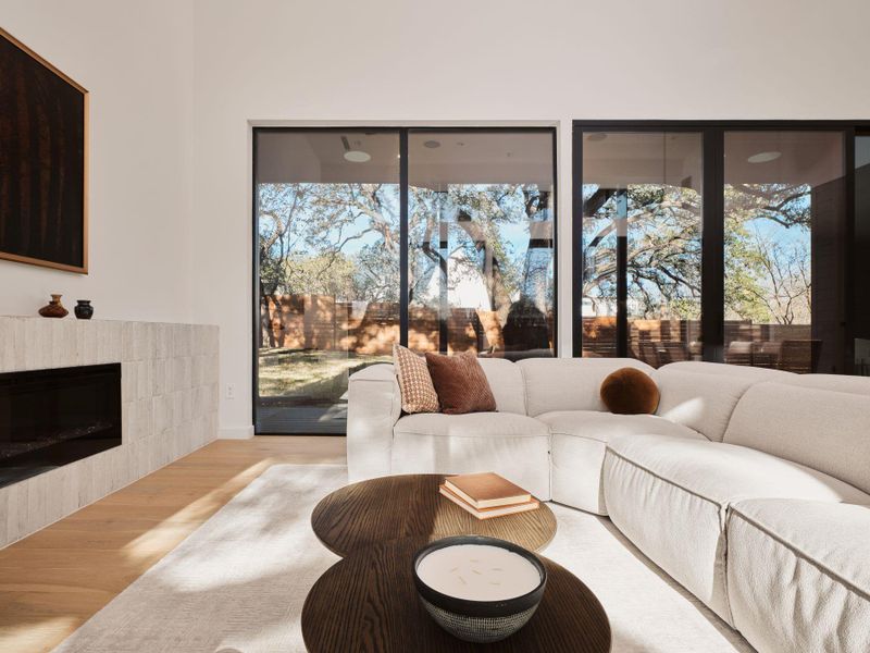 Living room with wood finished floors and a tiled fireplace
