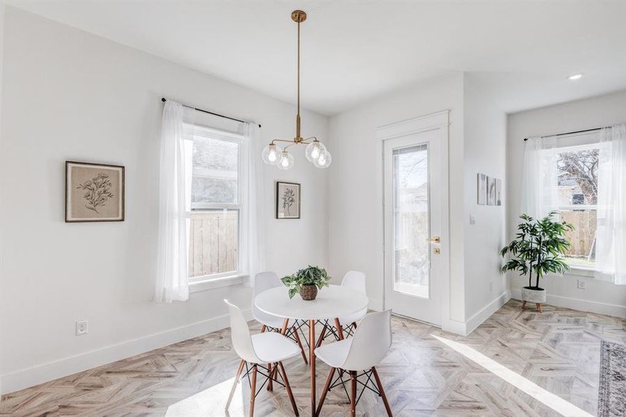 Dining room featuring an inviting chandelier and light parquet floors