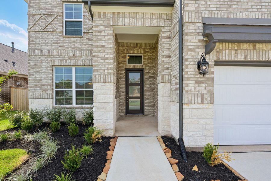 Front exterior of a new home in Kingdom Heights, Rosenberg, TX, highlighting curb appeal (Image 27). Front exterior of a new home in Kingdom Heights, Rosenberg, TX, highlighting curb appeal (Image 27).