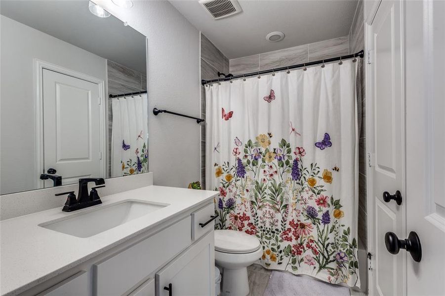 Full bath featuring vanity and toilet