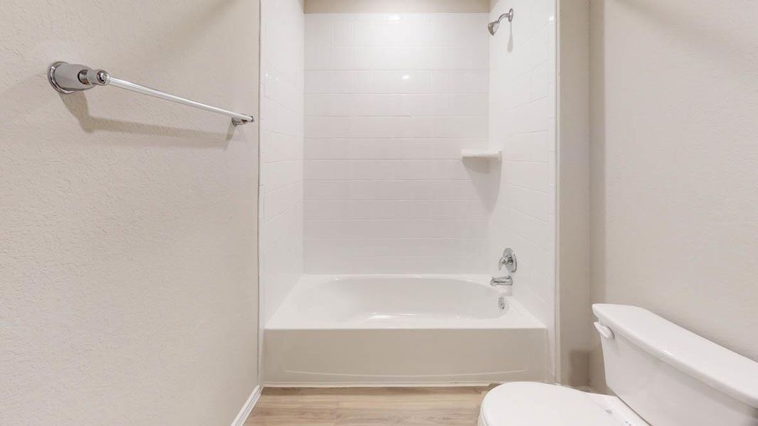 A well-maintained bathroom with a combination shower and tub. A well-maintained bathroom with a combination shower and tub.