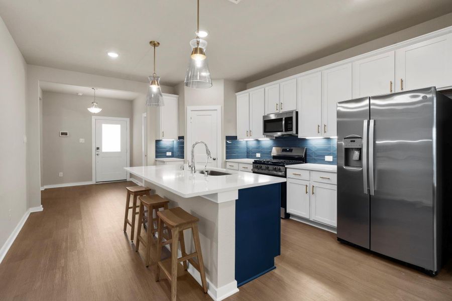 Bright kitchen with breakfast bar and prep space Bright kitchen with breakfast bar and prep space