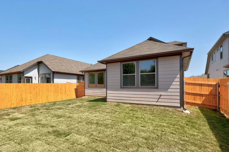 Front exterior of a new home in Trinity Ranch, Elgin, TX, highlighting curb appeal (Image 2).