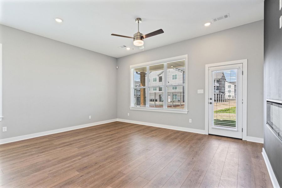 Spare room featuring a ceiling fan, dark wood-style floors, and recessed lighting