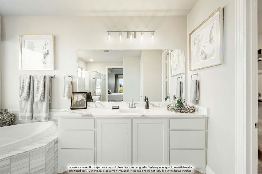 Bathroom with white vanity, large mirror, soaking tub, and light marble countertop
