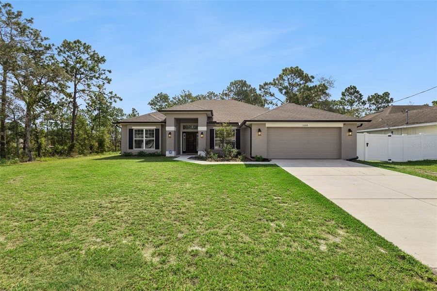 Front exterior of a new home in Royal Highlands, Weeki Wachee, FL, highlighting curb appeal (Image 20).