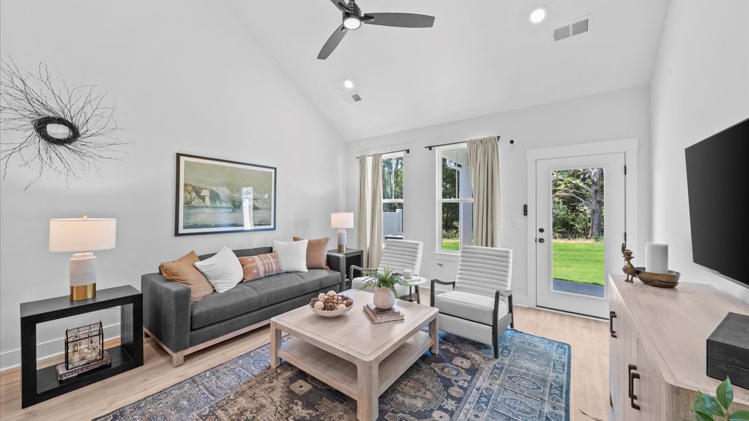 Tasteful family room with two-story volume, refined finishes, and exceptional natural light at Barton Hollow