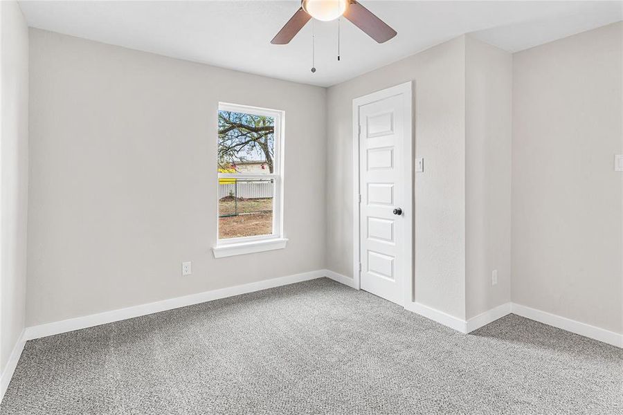 Spare room featuring carpet and baseboards