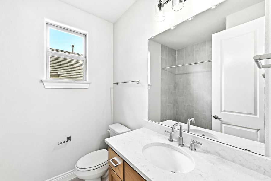 Bathroom featuring a single vanity with an integrated sink, polished chrome fixtures, and a white countertop