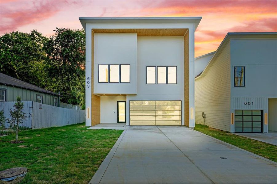 Contemporary house with an attached garage, stucco siding, and concrete driveway Contemporary house with an attached garage, stucco siding, and concrete driveway