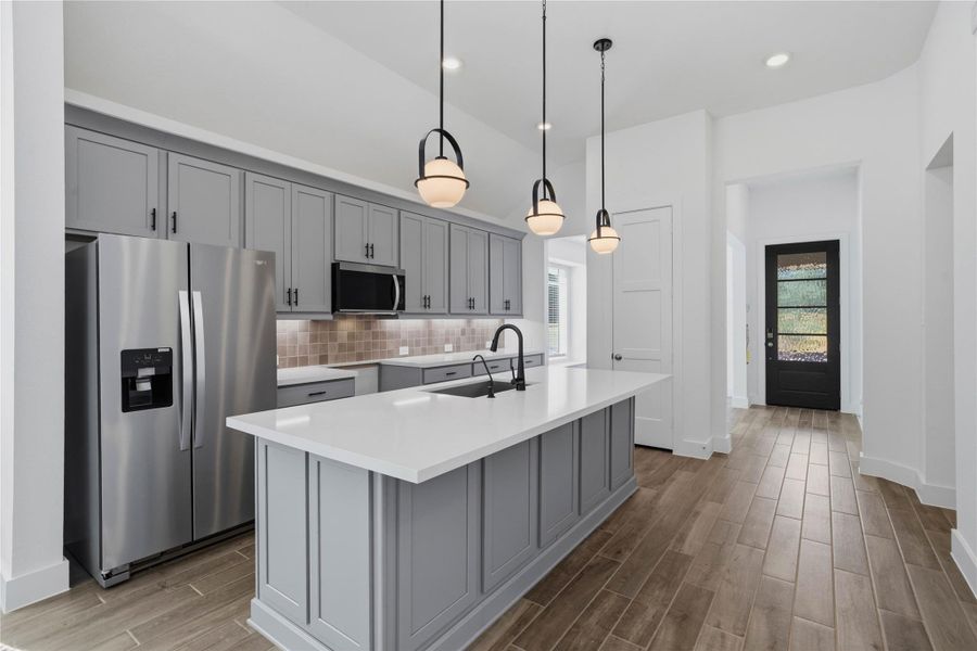 Elegant paneled details wrap the massive breakfast bar island, offering ample space for casual barstool seating and entertaining. Elegant paneled details wrap the massive breakfast bar island, offering ample space for casual barstool seating and entertaining.