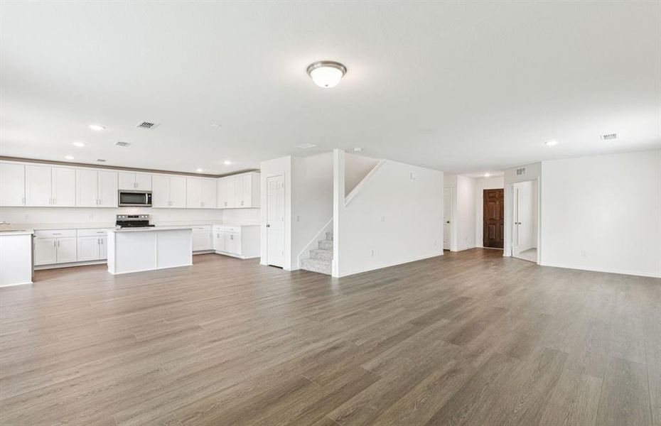 Expansive gathering room bathed in natural sunlight *Real home pictured Expansive gathering room bathed in natural sunlight *Real home pictured