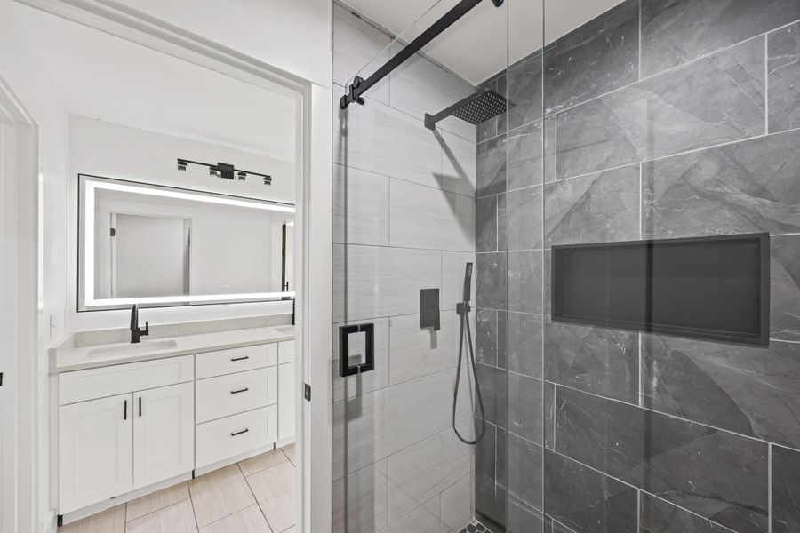 Bathroom with a shower stall and vanity