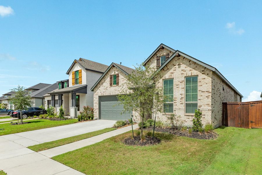 Another side view of your new home showcasing the spacious backyard and professional landscaping.