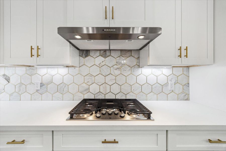 You turn around and are captivated by a stunning GE five-burner cooktop that will elevate your cooking experience. You turn around and are captivated by a stunning GE five-burner cooktop that will elevate your cooking experience.