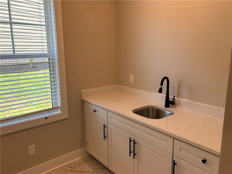Well-lit utility room with ample countertop space