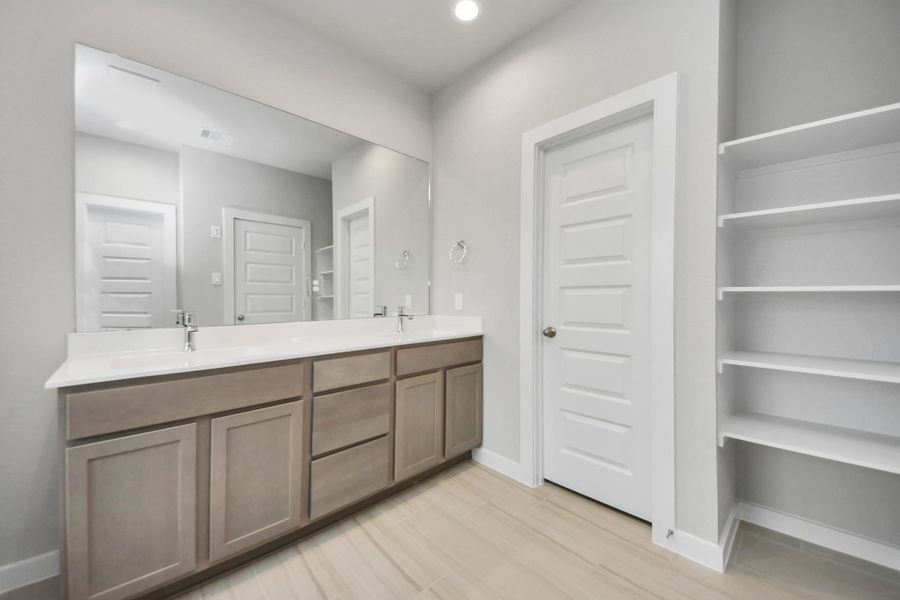 Elevate your dailyroutine at the elegant vanity, now equipped with double sinks, lightcountertops, modern hardware, and beautiful recessed lights. Sample photo of completed home with similar floor plan. Actual colors and selections may vary. Elevate your dailyroutine at the elegant vanity, now equipped with double sinks, lightcountertops, modern hardware, and beautiful recessed lights. Sample photo of completed home with similar floor plan. Actual colors and selections may vary.