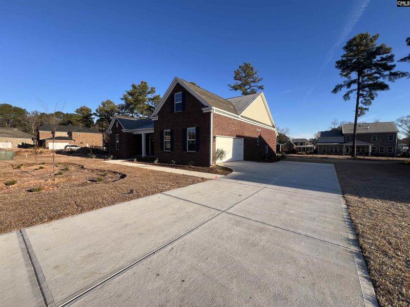 Front exterior of a new home in The Cove, Sumter, SC, highlighting curb appeal (Image 2).