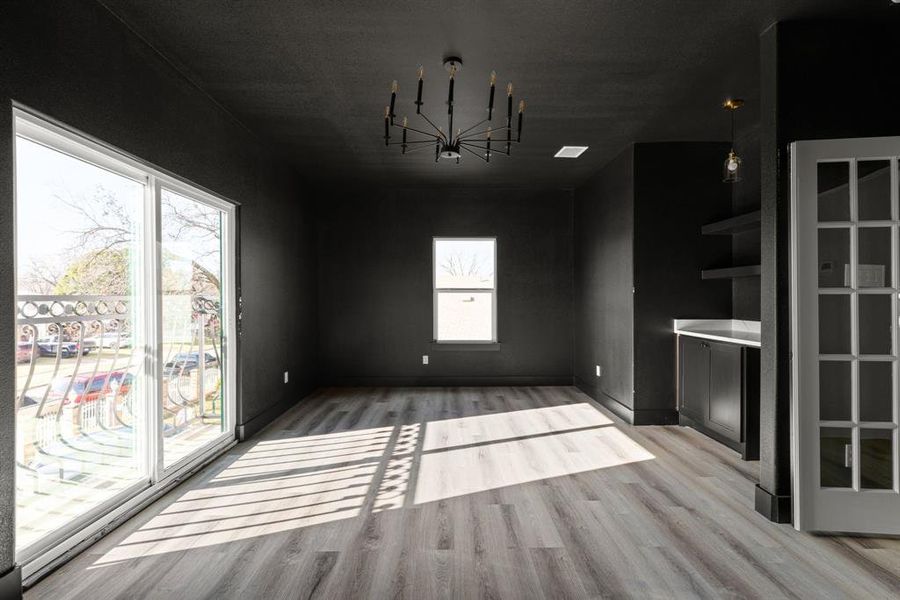 Game room with a chandelier, a healthy amount of sunlight, and light hardwood / wood-style floors