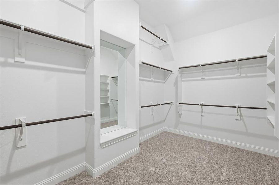 Spacious closet with light carpet Spacious closet with light carpet