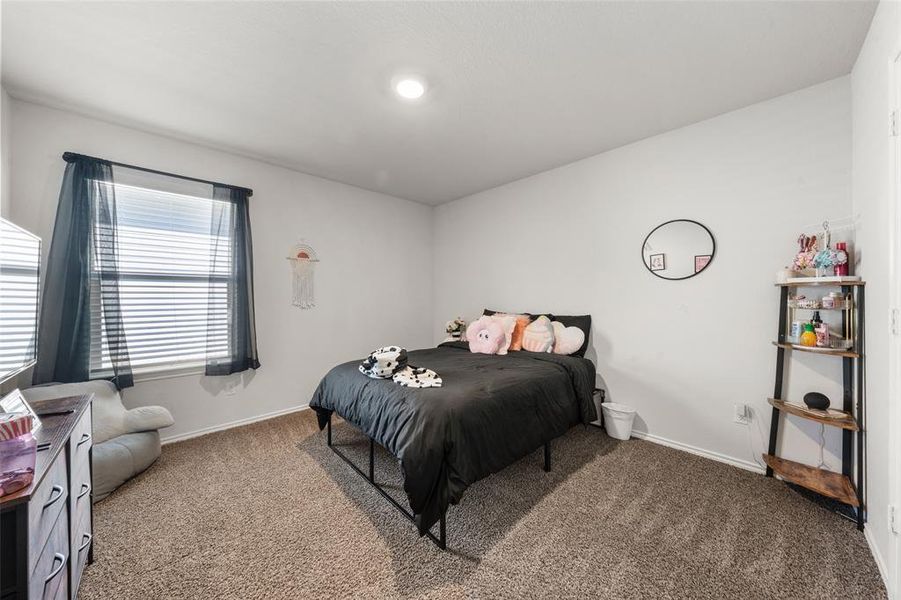 Carpeted bedroom featuring baseboards