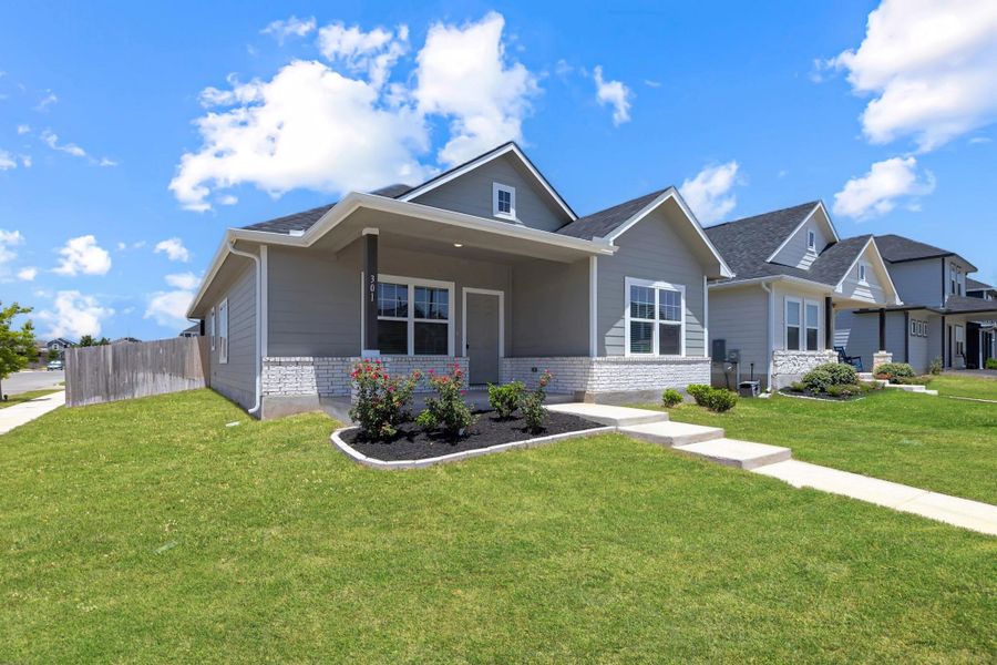 View of front facade featuring brick siding and covered porch View of front facade featuring brick siding and covered porch